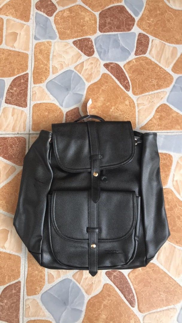 Black Faux Leather Convertible Backpack Shoulder Bag (Category: Backpacks) located in Quezon City. Submitted by davidmelvin28 (Listing ID 1465590563, Image 1). Description: - Color: Black with chic gold-tone hardware - Material: Premium faux leather with a stylish grained texture - Condition: Brand new with tag still attached - Closure: Flap with snap button and secure drawstring top - Storage: Convenient front pocket for easy access - Versatile: