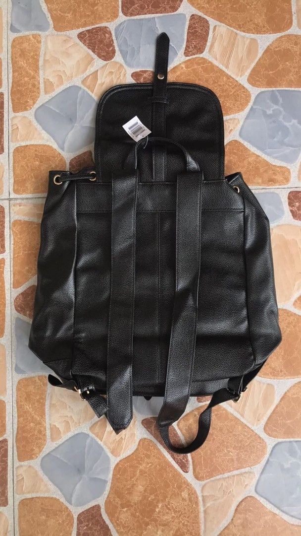 Black Faux Leather Convertible Backpack Shoulder Bag (Category: Backpacks) located in Quezon City. Submitted by davidmelvin28 (Listing ID 1465590563, Image 2). Description: - Color: Black with chic gold-tone hardware - Material: Premium faux leather with a stylish grained texture - Condition: Brand new with tag still attached - Closure: Flap with snap button and secure drawstring top - Storage: Convenient front pocket for easy access - Versatile: