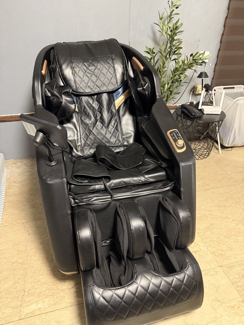 Black Full Body Massage Chair with Touch Screen Controller (Category: Massage Devices) located in Manila. Submitted by shemineforever (Listing ID 1465681896, Image 2). Description: - Premium black leather full body massage chair featuring elegant quilted diamond stitching and gold-toned trim - Built-in control tablet conveniently located on the armrest for easy adjustments - Comprehensive massage features including extra arm/hand massagers and de