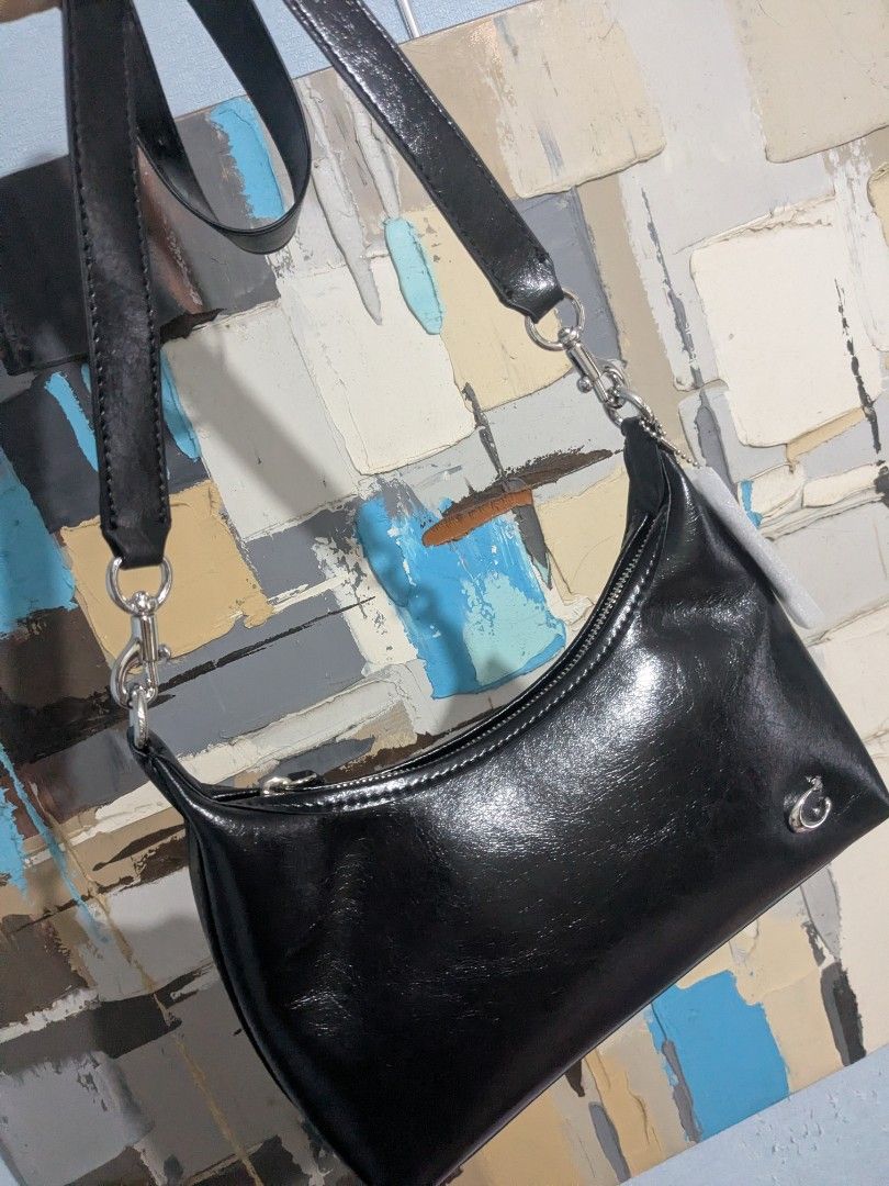 Black Juliet shoulder bag with silver hardware and chain strap (Category: Shoulder Bags) located in Las Pinas. Submitted by luxlahvu2017 (Listing ID 1465704054, Image 1). Description: - Color: Glossy Black - Material: Premium synthetic leather - Closure: Top zip with fabric pull tab - Hardware: Silver-tone with small metallic logo emblem on front - Straps: Includes 2 interchangeable straps (1 black leather strap and 1 silver chain link strap) - I