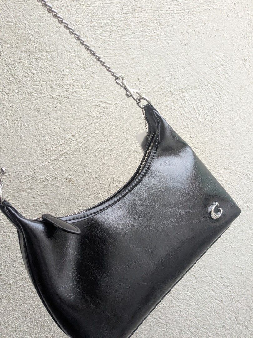 Black Juliet shoulder bag with silver hardware and chain strap (Category: Shoulder Bags) located in Las Pinas. Submitted by luxlahvu2017 (Listing ID 1465704054, Image 3). Description: - Color: Glossy Black - Material: Premium synthetic leather - Closure: Top zip with fabric pull tab - Hardware: Silver-tone with small metallic logo emblem on front - Straps: Includes 2 interchangeable straps (1 black leather strap and 1 silver chain link strap) - I