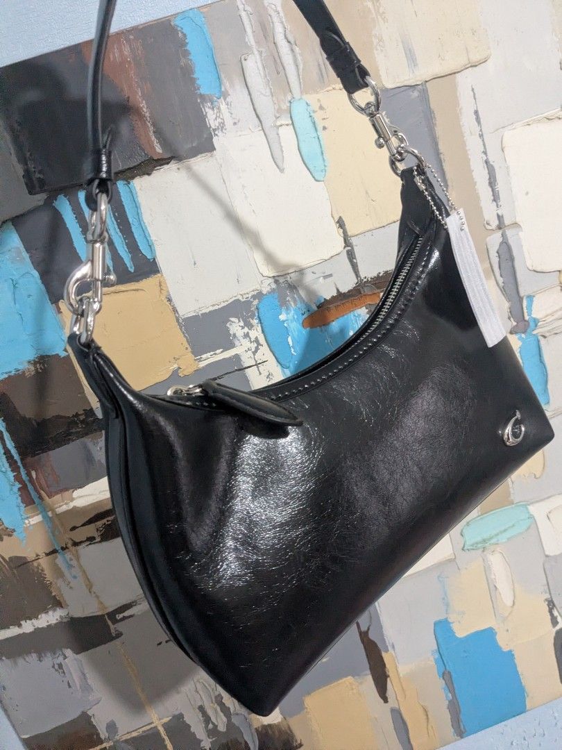 Black Juliet shoulder bag with silver hardware and chain strap (Category: Shoulder Bags) located in Las Pinas. Submitted by luxlahvu2017 (Listing ID 1465704054, Image 2). Description: - Color: Glossy Black - Material: Premium synthetic leather - Closure: Top zip with fabric pull tab - Hardware: Silver-tone with small metallic logo emblem on front - Straps: Includes 2 interchangeable straps (1 black leather strap and 1 silver chain link strap) - I