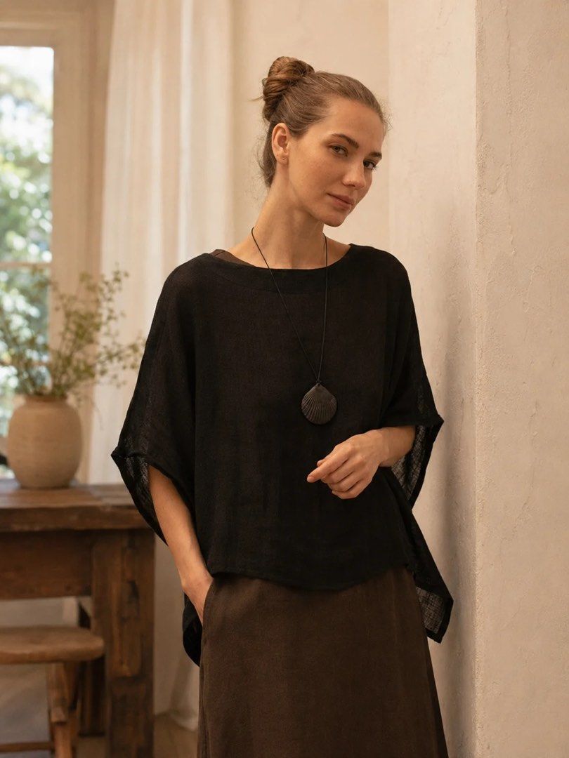 Black Loose Fit Short Sleeve Blouse (Category: Blouses) located in Manila. Submitted by anabri (Listing ID 1465713187, Image 2). Description: - Color: Classic Black - Fit: Loose and relaxed - Design: Round neckline with a button-down back placket - Fabric: Lightweight, slightly sheer with a subtle texture - Hem: Curved with slightly lower sides - Styling: Great basic piece for layering or wearing solo - GREAT FOR LAYERING - SECOND AND LAST PHOTOS