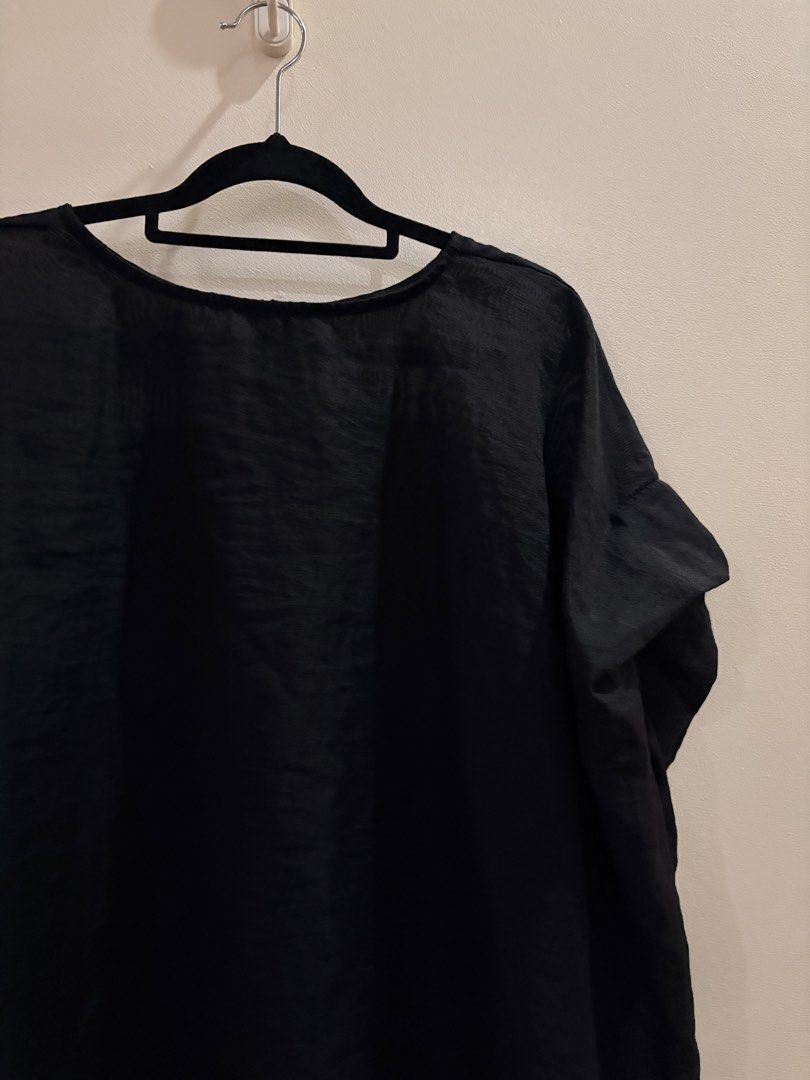 Black Loose Fit Short Sleeve Blouse (Category: Blouses) located in Manila. Submitted by anabri (Listing ID 1465713187, Image 3). Description: - Color: Classic Black - Fit: Loose and relaxed - Design: Round neckline with a button-down back placket - Fabric: Lightweight, slightly sheer with a subtle texture - Hem: Curved with slightly lower sides - Styling: Great basic piece for layering or wearing solo - GREAT FOR LAYERING - SECOND AND LAST PHOTOS