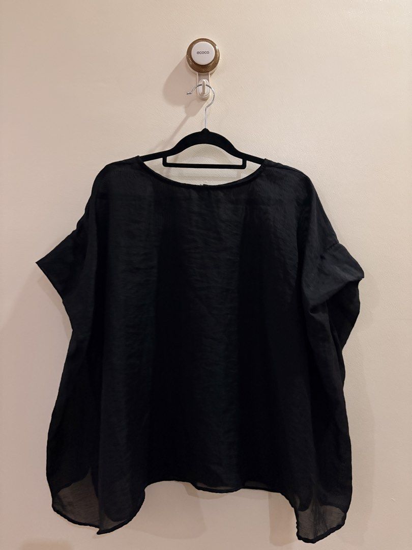 Black Loose Fit Short Sleeve Blouse (Category: Blouses) located in Manila. Submitted by anabri (Listing ID 1465713187, Image 1). Description: - Color: Classic Black - Fit: Loose and relaxed - Design: Round neckline with a button-down back placket - Fabric: Lightweight, slightly sheer with a subtle texture - Hem: Curved with slightly lower sides - Styling: Great basic piece for layering or wearing solo - GREAT FOR LAYERING - SECOND AND LAST PHOTOS