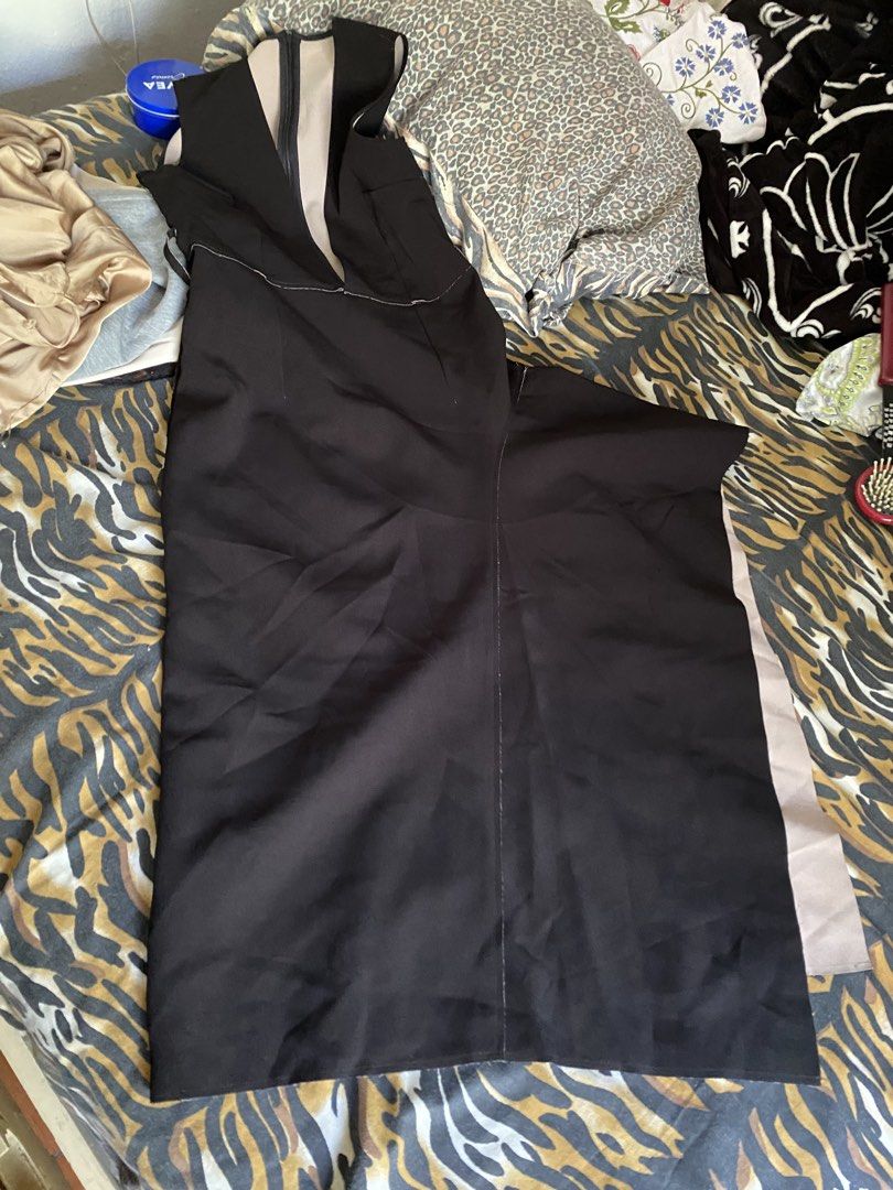 Black midi dress with beige contrast panel (Category: Dresses) located in Kalayaan. Submitted by kolaso29 (Listing ID 1465611049, Image 1). Description: - Style: Sleeveless black midi dress with a modern, clean cut - Details: Deep V-neckline with a contrasting beige front insert - Hem: Asymmetric hemline revealing a stylish beige lining - Fit: Flattering fitted waistline - Occasion: Perfect statement piece for dinners, parties, and formal events 