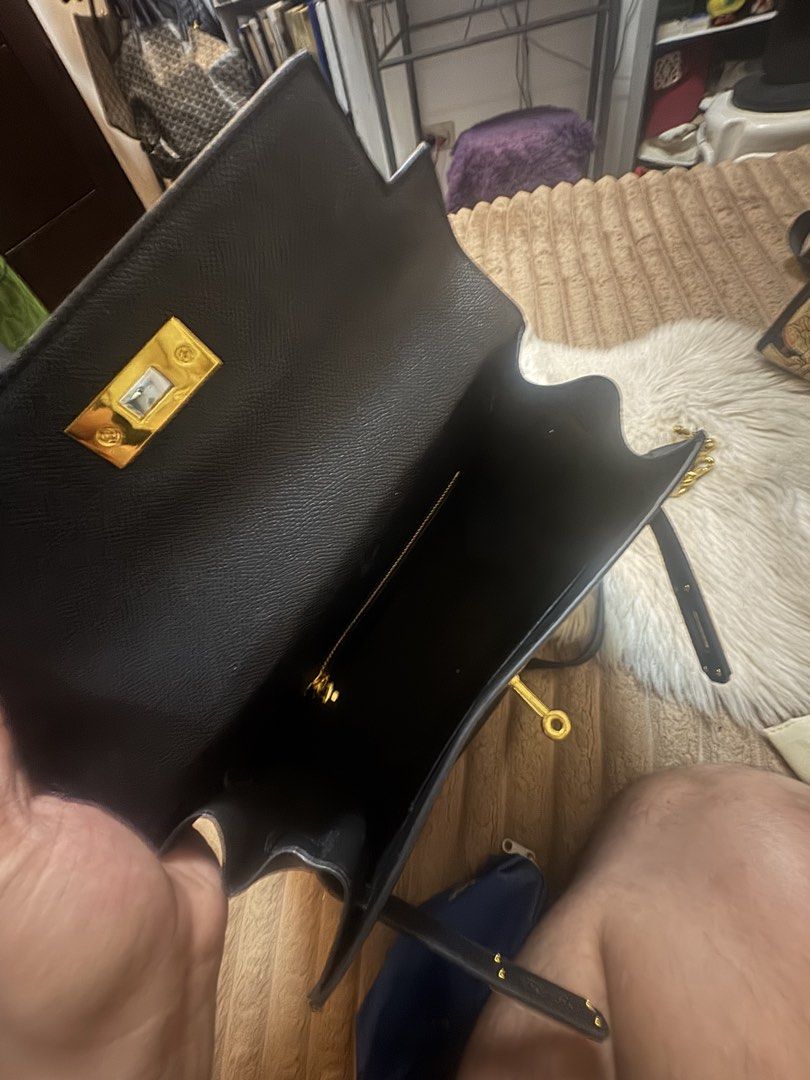 Black structured handbag with gold hardware and shoulder strap (Category: Luxury Bags & Wallets) located in Cavite. Submitted by amaxxingfinds (Listing ID 1465628791, Image 3). Description: Birkin tote bag Kelly Style Color Black Location Bacoor Rfs: Declutter Size 29 CM Width 21 CM Height .