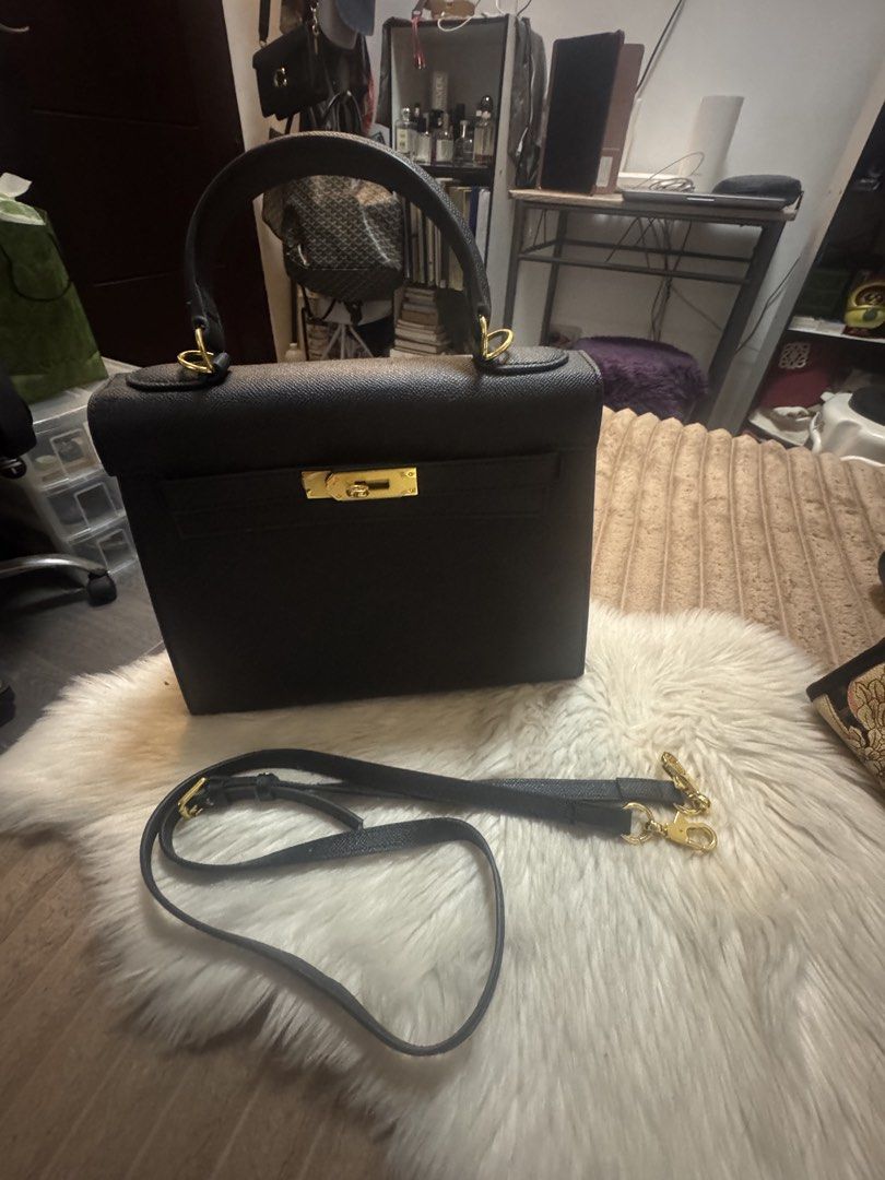 Black structured handbag with gold hardware and shoulder strap (Category: Luxury Bags & Wallets) located in Cavite. Submitted by amaxxingfinds (Listing ID 1465628791, Image 1). Description: Birkin tote bag Kelly Style Color Black Location Bacoor Rfs: Declutter Size 29 CM Width 21 CM Height .