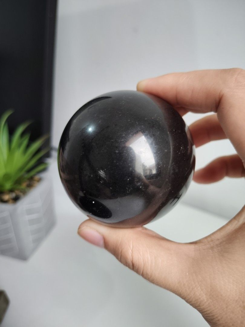 Black Tourmaline Sphere (Category: Precious Stones) located in Cavite. Submitted by lynlcb (Listing ID 1465655090, Image 1). Description: - Smooth black crystal sphere with a high gloss finish - Fits comfortably in the palm of your hand with a solid weight - Deep dark tone with natural subtle texture visible under the light - Nicely polished all around - Great piece for display shelves or meditation practice - weight is 356g.