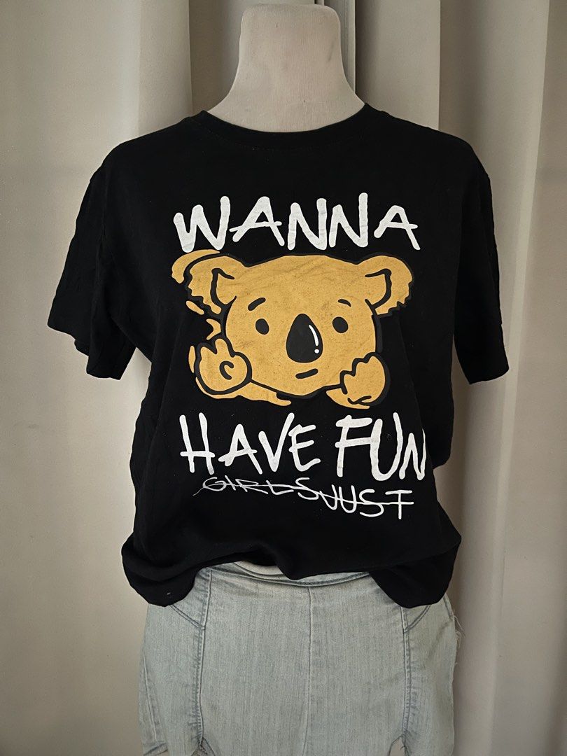Black T-Shirt with Funny Koala (Category: Shirts) located in Cainta. Submitted by zlove111 (Listing ID 1465758109, Image 2). Description: - Color: Black with bold yellow koala graphic - Design: 'Wanna Have Fun' text with 'Girls Just wanna have fun' crossed out - Material: Comfortable, breathable cotton fabric - Fit: Standard fit for everyday wear - Style: Quirky statement piece, easily paired with denim shorts or jeans - Condition: / Excellent (r