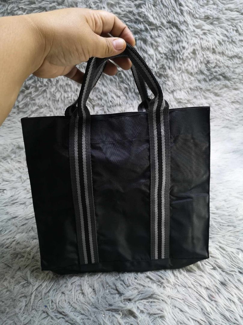 Black With Vertical Striped Design Tote Bag (Category: Tote Bags) located in Santa Cruz. Submitted by jmy_surplus.2 (Listing ID 1465688427, Image 2). Description: Size ; L -10.4 W - 11 Color ; Black Type ; Tote Bag Brand ; No brand Material ; Nylon Style ; Black Tote bag LR 129 JMY 5 Batch #224.