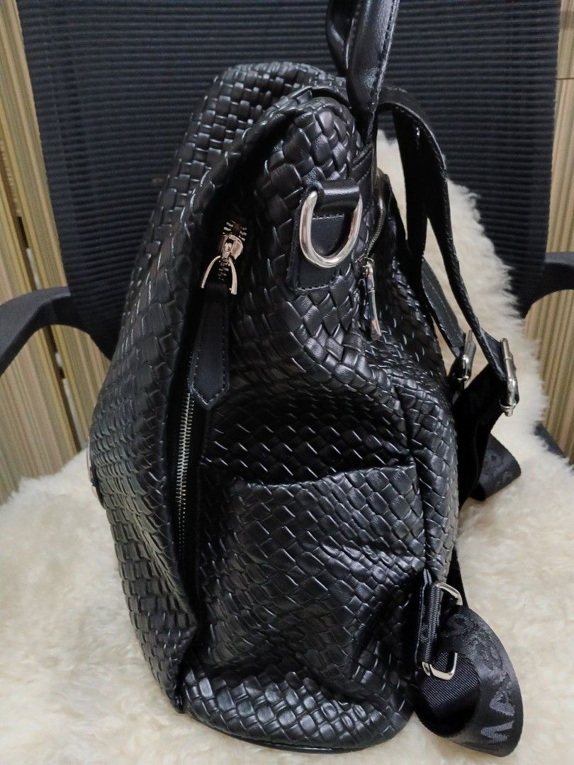 Black Woven Leather Backpack with Silver Hardware (Category: Backpacks) located in Taguig. Submitted by demsclosetph (Listing ID 1465608416, Image 3). Description: - Stylish black woven design all over - Eye-catching silver-tone round logo badge with rhinestone accents - Dual adjustable nylon straps and convenient top handle - Secure zip closure for the main compartment - Handy exterior pocket for quick access essentials - Flat, smooth base for s