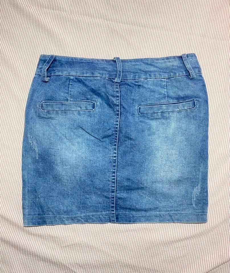 Blue Denim Mini Skirt (Category: Skirts) located in Manila. Submitted by lucky_jinky (Listing ID 1465629179, Image 3). Description: -Code:A26 W:28-30 L:15 - Style: Casual blue denim mini skirt with a stylish washed finish - Closure & Details: Front button closure, belt loops, and front pockets - Accents: Small decorative patch near the bottom hem and two back welt pockets - Size & Fit: Tag indicates waist 28-30 and length 13 - Versatility: Super 