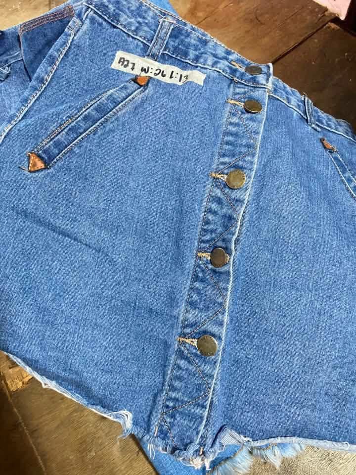 Blue Denim Mini Skirt with Front Buttons Raw Hem (Category: Skirts) located in Manila. Submitted by lucky_jinky (Listing ID 1465629354, Image 3). Description: Code:A26 W:26 L:13 - Style: High-waisted blue denim mini skirt in a classic vintage wash - Size: Waist 26, Length 13 (Brand new with tag attached) - Details: Front button closure with gold-toned hardware, front angled pockets, and two back pockets with subtle distressing - Hem: Trendy raw, 