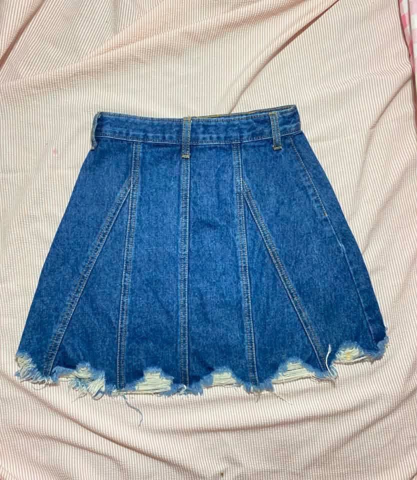 Blue Denim Skirt Distressed Hem Size 24 (Category: Skirts) located in Manila. Submitted by lucky_jinky (Listing ID 1465631396, Image 3). Description: W:24-25 L:14 - Style: Classic skater silhouette with structured vertical panels - Fit: High-waisted with button closure and belt loops - Details: Distressed raw hem and dark wash denim - Label Size: A5 (Waist: 24-25 inches, Length: 19 inches) - Condition: Excellent, ready to wear.