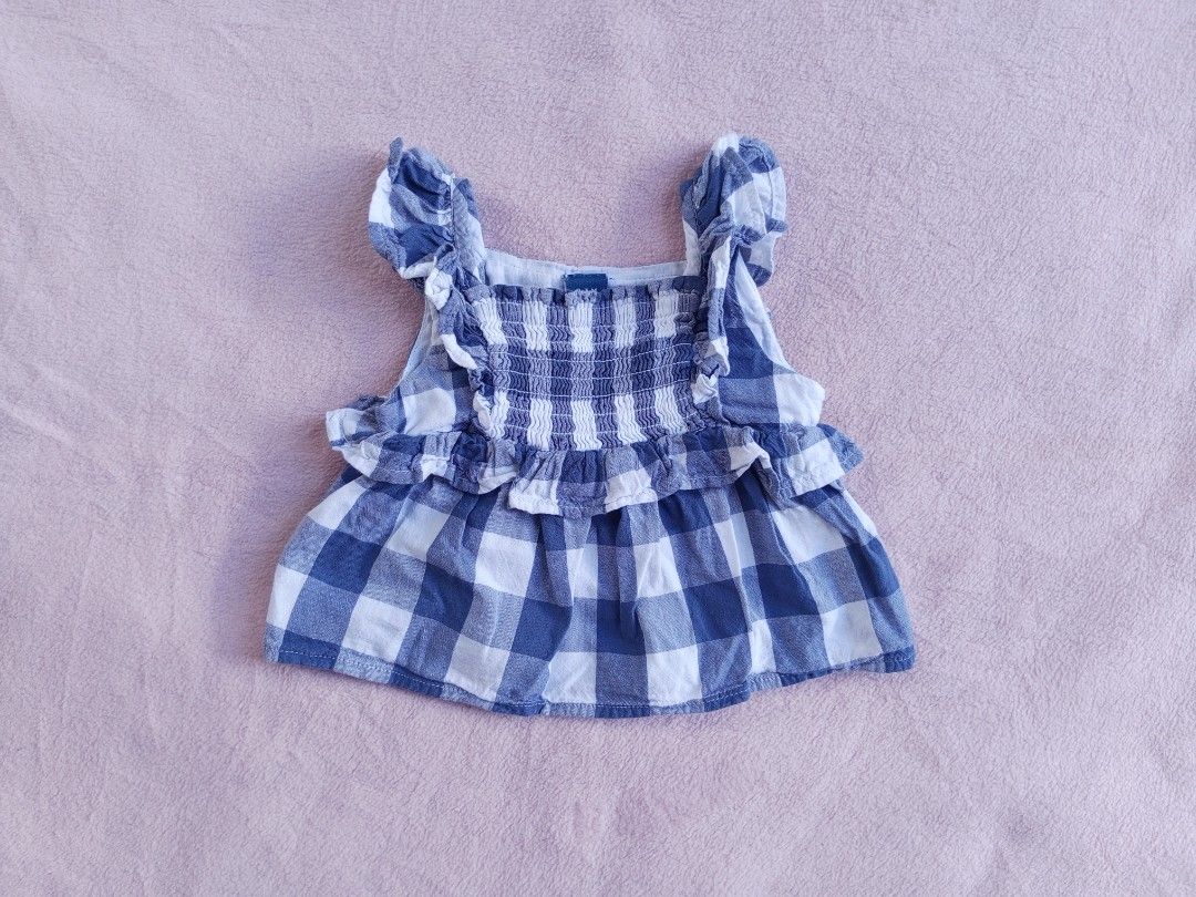 Blue Gingham Ruffle Top (Category: Babies & Kids Fashion) located in Sipocot. Submitted by mszari (Listing ID 1465754068, Image 1). Description: Details: Classic checkered, smocked bodice, ruffle tiers, flutter straps — timeless & easy to pair! Size: 3-6 months Condition: Clean, colors fresh ✅.