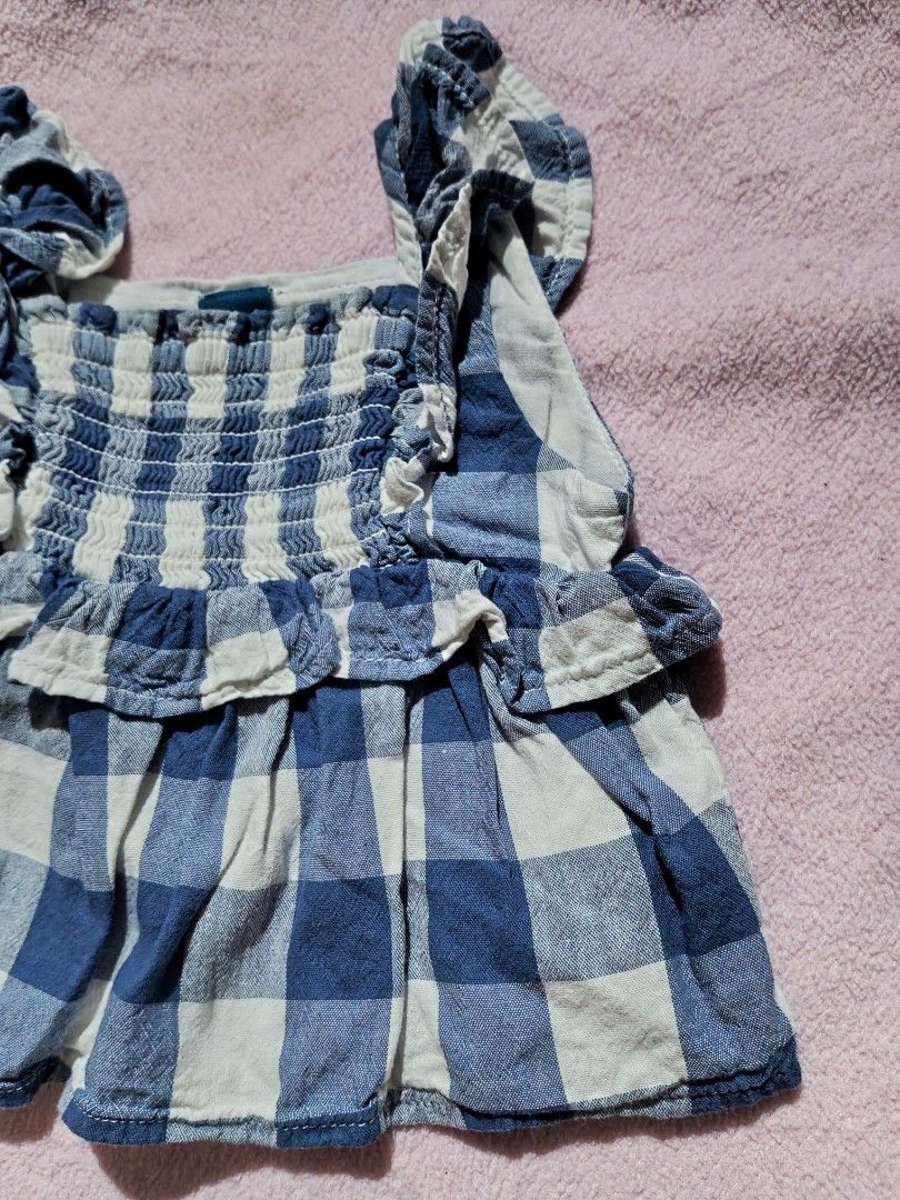 Blue Gingham Ruffle Top (Category: Babies & Kids Fashion) located in Sipocot. Submitted by mszari (Listing ID 1465754068, Image 2). Description: Details: Classic checkered, smocked bodice, ruffle tiers, flutter straps — timeless & easy to pair! Size: 3-6 months Condition: Clean, colors fresh ✅.