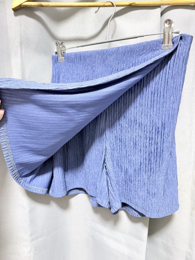 Blue Pleated Skorts (Category: Skirts) located in Manila. Submitted by saichyy (Listing ID 1465663196, Image 2). Description: - Color: Blue - Design: Asymmetric wrap-front with hidden shorts underneath - Fabric: Textured, crinkled material that requires no ironing - Style: Casual, easy to pair with basic tops - Construction: Clean hems and solid build for everyday wear.