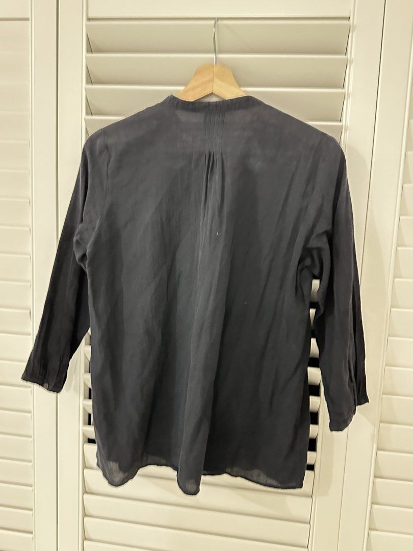 Blue Snowflake Pattern Button-Down Blouse (Category: Blouses) located in Singapore. Submitted by kindermum (Listing ID 1465699877, Image 6). Description: - Color & Pattern: Dark blue with all-over snowflake print - Material: Lightweight, semi-sheer fabric - Sleeves: Three-quarter length with button cuffs - Collar: Rounded in front, band collar on the reverse - 9/10 condition for this blue collar button up Blouse - Muji Top Condition: Includes a s