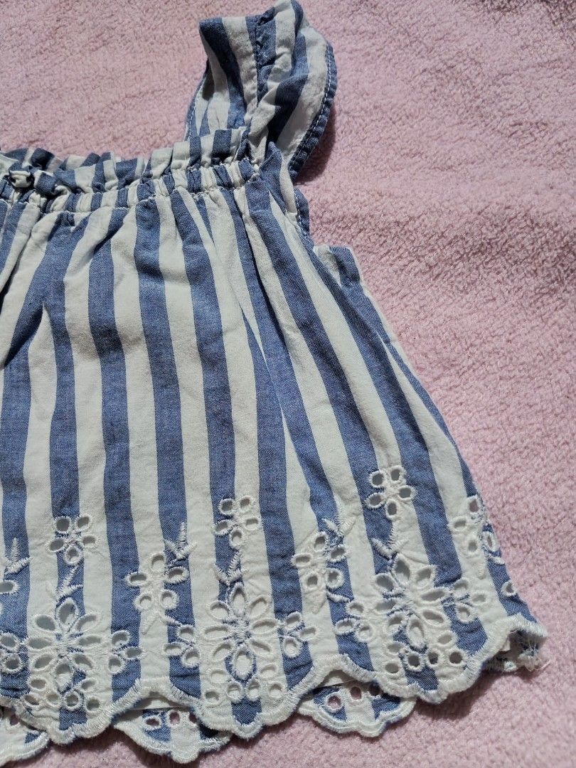 Blue Striped Eyelet top (Category: Babies & Kids Fashion) located in Sipocot. Submitted by mszari (Listing ID 1465753534, Image 2). Description: Details: Soft woven cotton, scalloped floral eyelet hem, elastic neckline, flutter sleeves — so pretty & delicate! Size: 3 months / runs big can fit up to 9 mos Condition: Well-kept, no loose threads ✨.