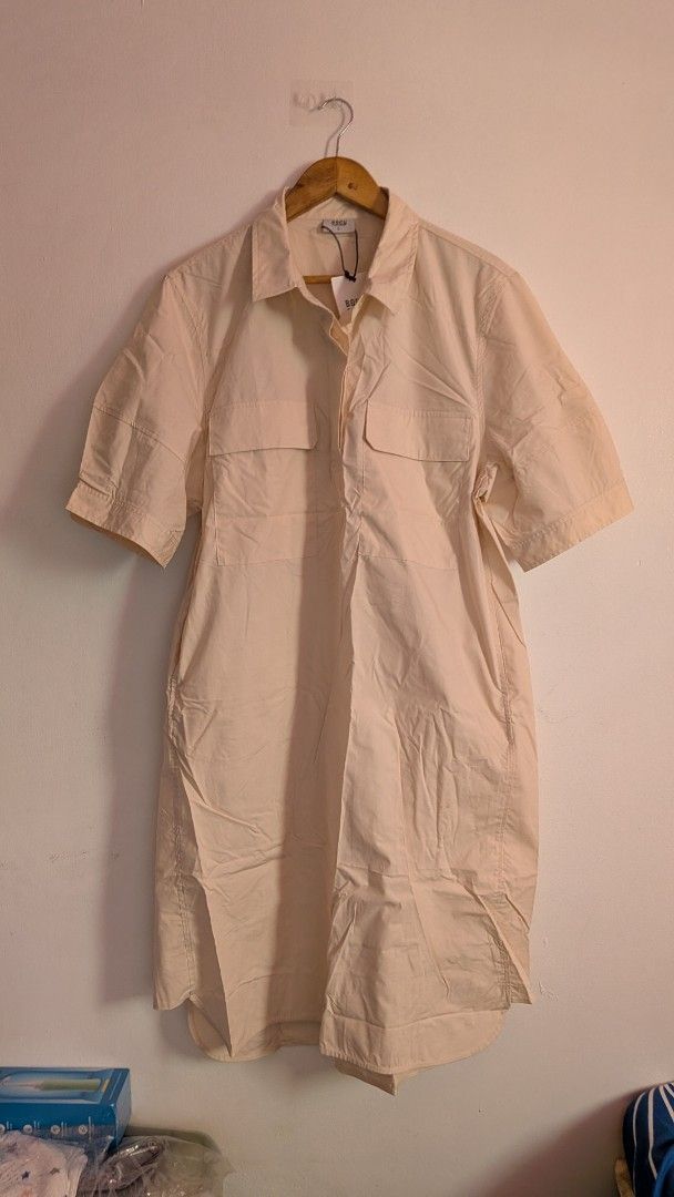 BOCU Oatmilk Dress Size L (Category: Dresses) located in Quezon City. Submitted by maff_mallow (Listing ID 1465605375, Image 1). Description: - Brand: BOCU, 100%cotton -Dress Length from top to bottom: 42inches - Color: Oatmilk - Size: Large - Condition: Brand new with tag attached (BNWT) - Details: Short sleeves with button cuffs, pointed collar, front button placket - Pockets: Dual chest flap pockets and functional side pockets - Hemline: Curve