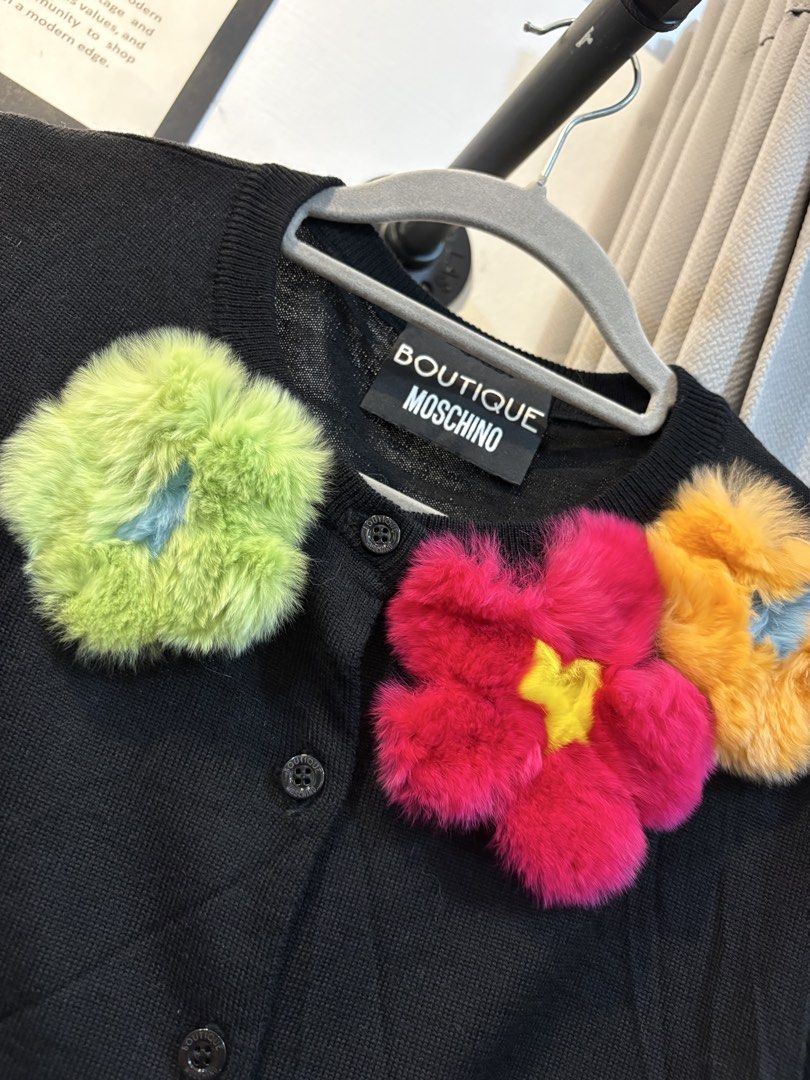 Boutiue Moschino Cardigan (Category: Coats, Jackets and Outerwear) located in Echague. Submitted by jake_rc (Listing ID 1465669578, Image 2). Description: Boutique Moschino features playful, fuzzy faux-fur flower appliqués in bright shades of green, hot pink, and orange near the neckline. Size France 40 Dimensions width 19 x length 19 Excellent condition No issue Price 650 plus SF.