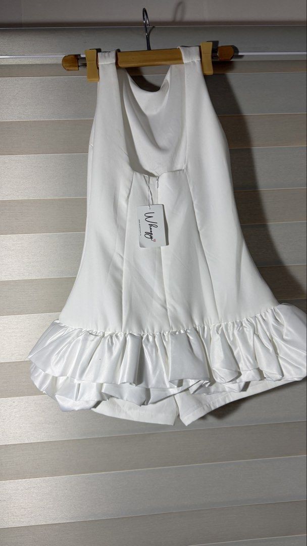 Brand New Whoopy White Ruffle Hem Romper (Category: Rompers) located in Cabanatuan. Submitted by jstne_ (Listing ID 1465634451, Image 2). Description: - Brand: Whoopy - Color: White - Style: Sleeveless romper with satin ruffle hem - Closure: Back zipper - Condition: Brand new with tag attached (small brown spot on the ruffle, see last photo).