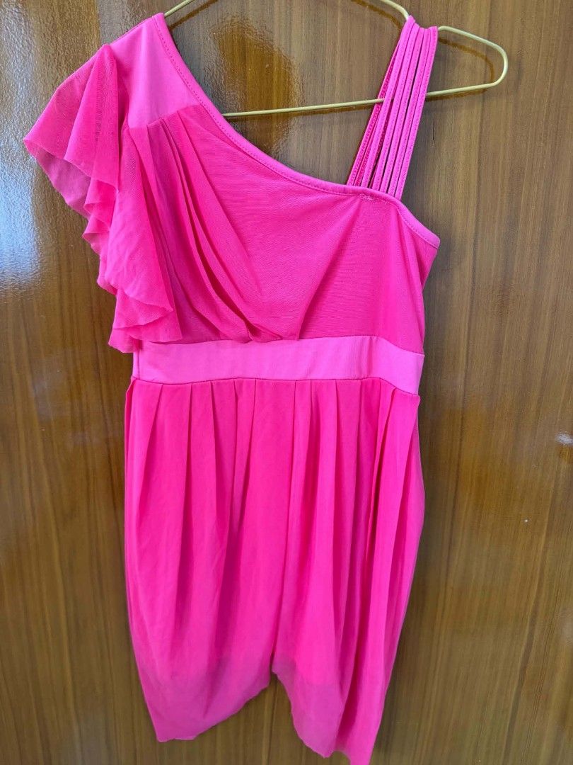 Bright Pink One-Shoulder Ruffle Mini Dress (Category: Dresses) located in Caloocan City. Submitted by mylove326 (Listing ID 1465682487, Image 2). Description: - Color: Vibrant hot pink - Design: Asymmetrical one-shoulder neckline with a dramatic ruffled sleeve and multi-strap detail - Fit: Fitted waist with a pleated, flared mini skirt and dipped hemline - Material: Lightweight chiffon-like fabric overlay - Condition: like new ndi nagamit - Perfe