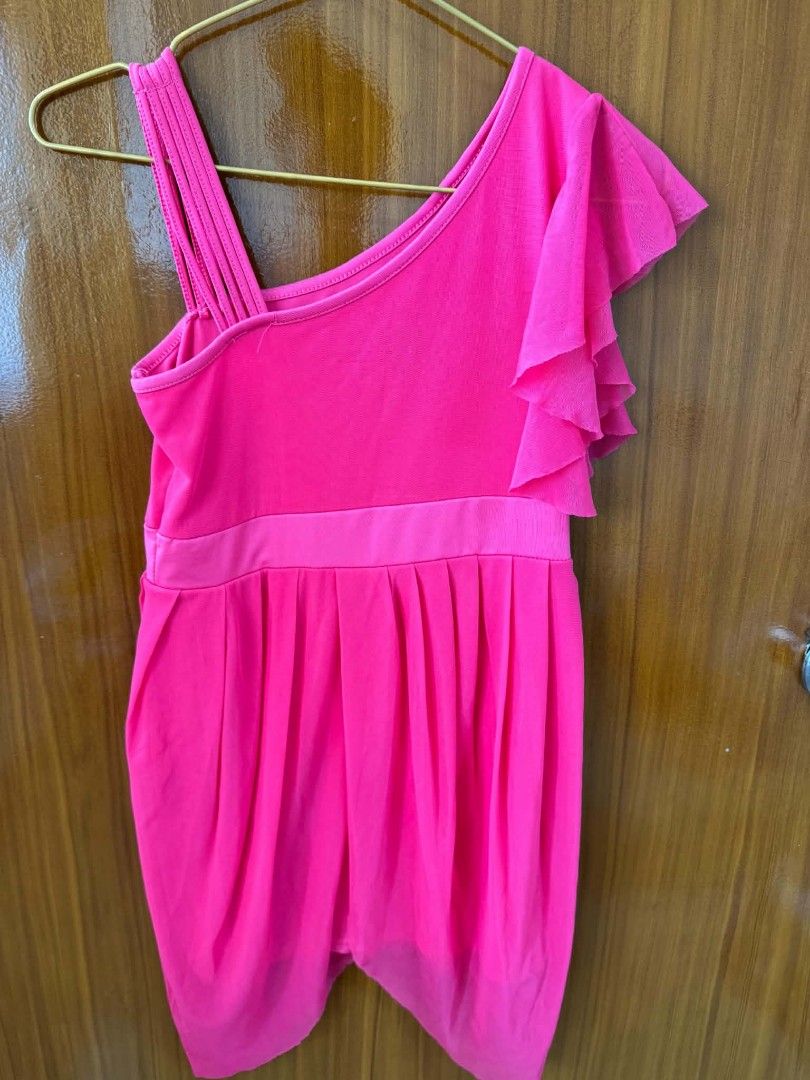 Bright Pink One-Shoulder Ruffle Mini Dress (Category: Dresses) located in Caloocan City. Submitted by mylove326 (Listing ID 1465682487, Image 3). Description: - Color: Vibrant hot pink - Design: Asymmetrical one-shoulder neckline with a dramatic ruffled sleeve and multi-strap detail - Fit: Fitted waist with a pleated, flared mini skirt and dipped hemline - Material: Lightweight chiffon-like fabric overlay - Condition: like new ndi nagamit - Perfe