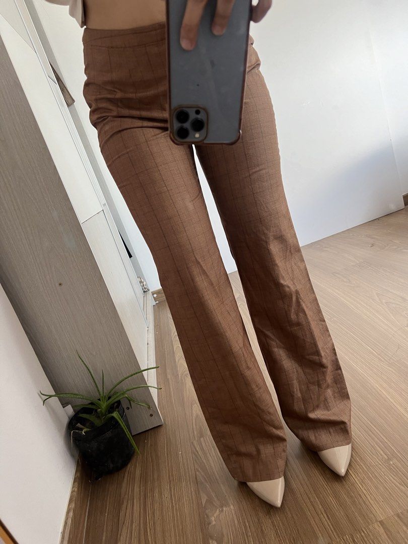 Brown Plaid High-Waisted Flare Trousers (Category: Jeans) located in Makati City. Submitted by warm.abc123 (Listing ID 1465588032, Image 2). Description: - Style: High-waisted, wide-leg flare - Pattern: Faint all-over plaid in classic brown - Material: Smooth, lightweight, and comfortable - Condition: Like new (worn only for try-on photo) - Perfect pairing: Looks amazing with pointed heels.