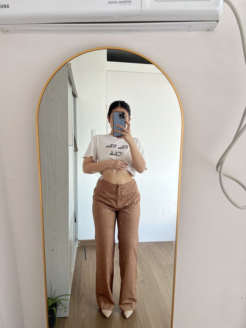 Brown Plaid High-Waisted Flare Trousers (Category: Jeans) located in Makati City. Submitted by warm.abc123 (Listing ID 1465588032, Image 1). Description: - Style: High-waisted, wide-leg flare - Pattern: Faint all-over plaid in classic brown - Material: Smooth, lightweight, and comfortable - Condition: Like new (worn only for try-on photo) - Perfect pairing: Looks amazing with pointed heels.