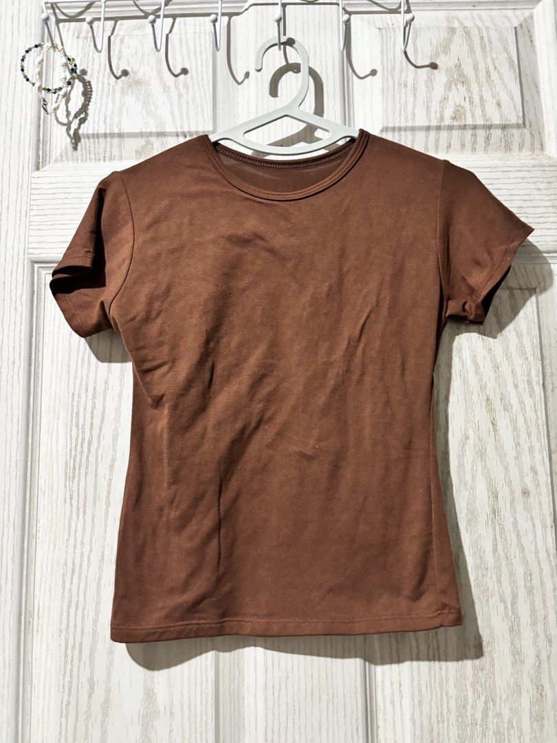 Brown Short Sleeve T-Shirt Basic Tee (Category: Shirts) located in Bautista. Submitted by abgciaa (Listing ID 1465623746, Image 3). Description: - Color: Brown - Style: Short sleeve t-shirt with a round neckline and casual fit - Fabric: Soft and comfortable - Length: Regular - Versatile everyday basic, easy to pair with jeans or skirts.