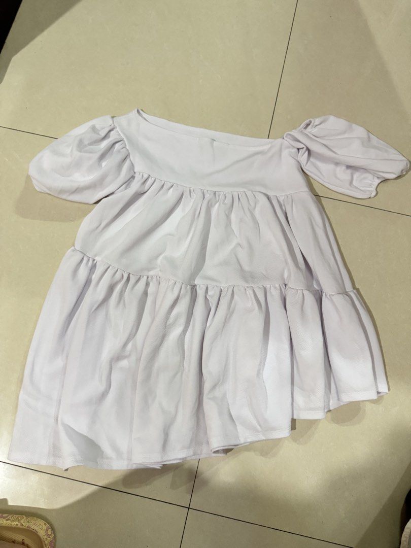 BSCO White Off-Shoulder Tiered Dress (Category: Dresses) located in Quezon City. Submitted by sweetlyluxe (Listing ID 1465624250, Image 3). Description: - Brand: BSCO - Size: Small - Color: White - Design: Off-shoulder neckline with short puff sleeves - Fabric: Textured material with flowy tiered layers - Versatile: Great to pair with jeans or skirts.