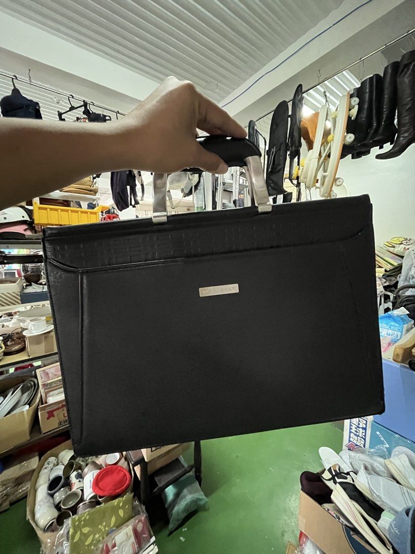 Burberry Black Leather Briefcase Document Bag (Category: Luxury Bags & Wallets) located in Manila. Submitted by batusaipus03057 (Listing ID 1465623081, Image 3). Description: - Authentic black leather Burberry briefcase - Sleek silver-tone hardware with front metal brand plaque - Dual metal handles with comfortable black grip - Secure zip-around closure - Signature patterned fabric lining inside - Built-in zip pocket and compartment slots for org