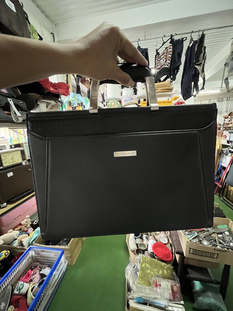 Burberry Black Leather Briefcase Document Bag (Category: Luxury Bags & Wallets) located in Manila. Submitted by batusaipus03057 (Listing ID 1465623081, Image 1). Description: - Authentic black leather Burberry briefcase - Sleek silver-tone hardware with front metal brand plaque - Dual metal handles with comfortable black grip - Secure zip-around closure - Signature patterned fabric lining inside - Built-in zip pocket and compartment slots for org