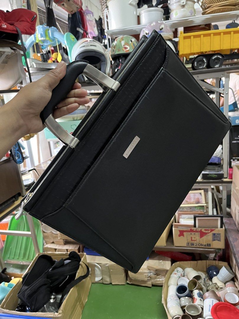 Burberry Black Leather Briefcase Document Bag (Category: Luxury Bags & Wallets) located in Manila. Submitted by batusaipus03057 (Listing ID 1465623081, Image 2). Description: - Authentic black leather Burberry briefcase - Sleek silver-tone hardware with front metal brand plaque - Dual metal handles with comfortable black grip - Secure zip-around closure - Signature patterned fabric lining inside - Built-in zip pocket and compartment slots for org