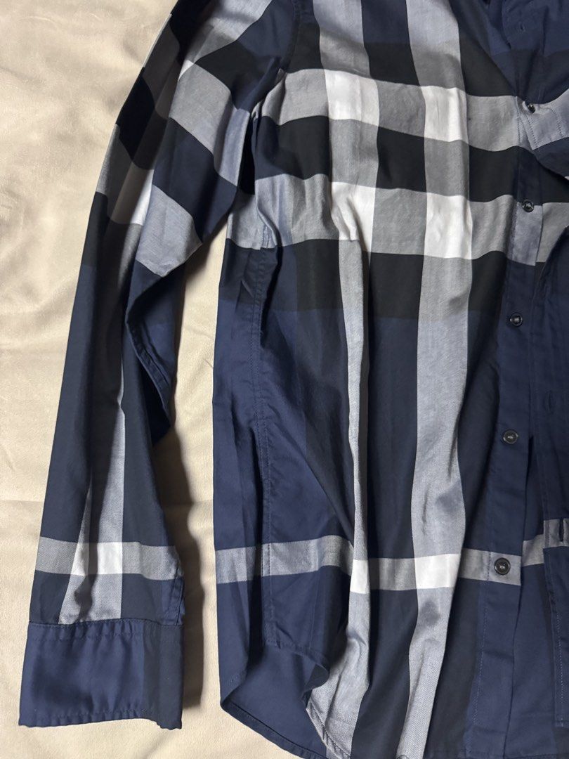 Burberry Blue Plaid Button Down Shirt Long Sleeve (Category: Longsleeves) located in Manila. Submitted by seangoart (Listing ID 1465734905, Image 2). Description: - Brand: Burberry - Pattern: Classic check (Navy Blue, White, Grey) - Style: Long-sleeve button-down with front chest pocket and collar buttons - Material: Premium quality cotton - Fit: Standard sizing - Condition: Clean, excellent, and ready to wear - Perfect for smart casual and corpo