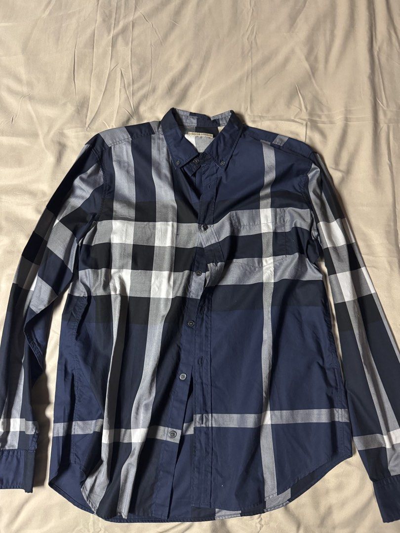 Burberry Blue Plaid Button Down Shirt Long Sleeve (Category: Longsleeves) located in Manila. Submitted by seangoart (Listing ID 1465734905, Image 1). Description: - Brand: Burberry - Pattern: Classic check (Navy Blue, White, Grey) - Style: Long-sleeve button-down with front chest pocket and collar buttons - Material: Premium quality cotton - Fit: Standard sizing - Condition: Clean, excellent, and ready to wear - Perfect for smart casual and corpo