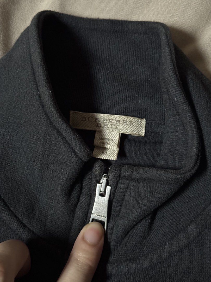 Burberry Brit Black Full Zip Jacket (Category: Coats, Jackets and Outerwear) located in Manila. Submitted by seangoart (Listing ID 1465585776, Image 2). Description: - Brand: Burberry Brit - Color: Classic Black - Size: Medium (true to fit) - Design: Stand collar with custom zipper pull and subtle embroidered chest logo - Detail: Iconic check pattern trim along the inner placket - Condition: Clean construction, comfortable fabric - Style: Great e