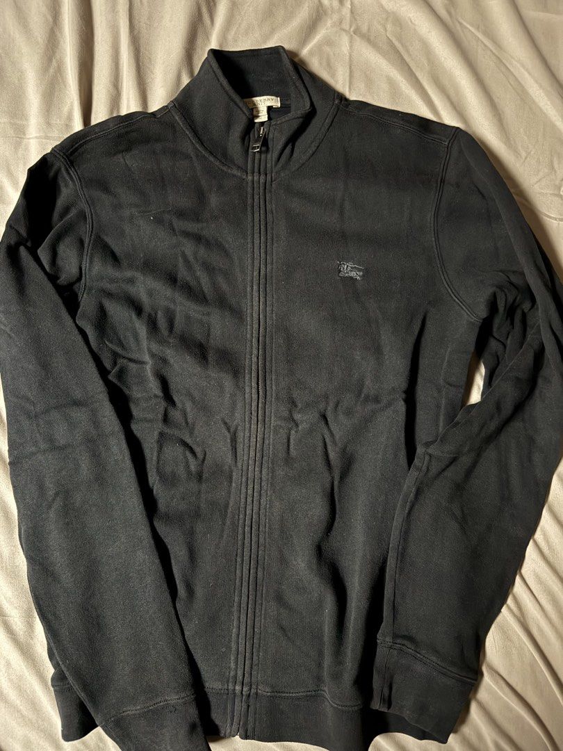 Burberry Brit Black Full Zip Jacket (Category: Coats, Jackets and Outerwear) located in Manila. Submitted by seangoart (Listing ID 1465585776, Image 1). Description: - Brand: Burberry Brit - Color: Classic Black - Size: Medium (true to fit) - Design: Stand collar with custom zipper pull and subtle embroidered chest logo - Detail: Iconic check pattern trim along the inner placket - Condition: Clean construction, comfortable fabric - Style: Great e