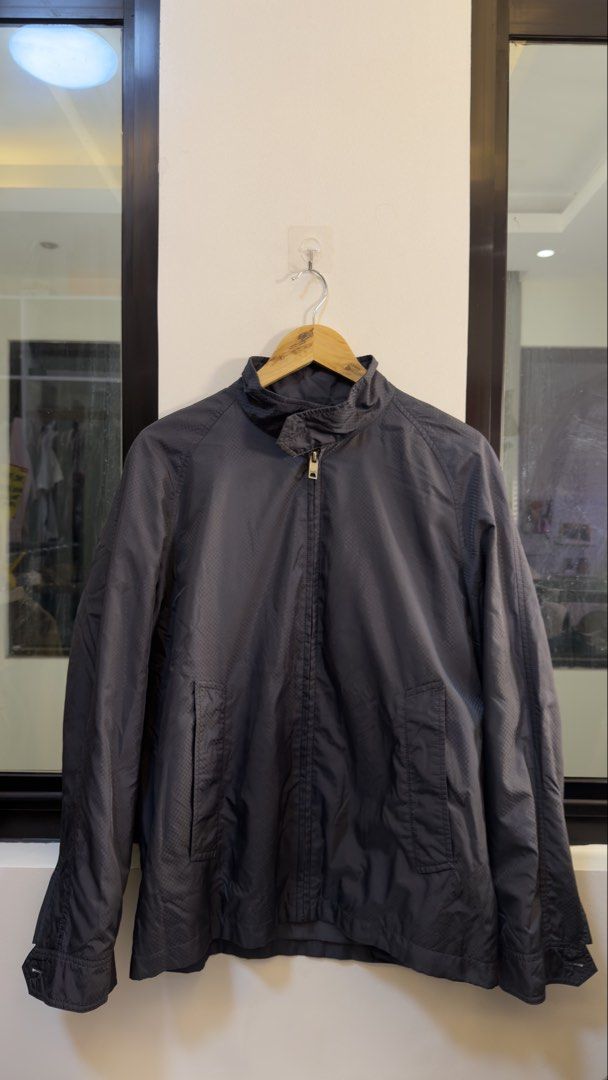 Burberry London Black Zip-Up Jacket (Category: Coats, Jackets and Outerwear) located in Paranaque City. Submitted by mykapoynton (Listing ID 1465682011, Image 2). Description: Burberry London Black Zip-Up Jacket - Color: Classic Black with iconic beige, black, and red check lining - Style: Zip-up jacket with mock neck collar and subtle checkered texture - Features: Front pockets, full metal zip closure, buttoned cuffs and back yoke - Versatility: