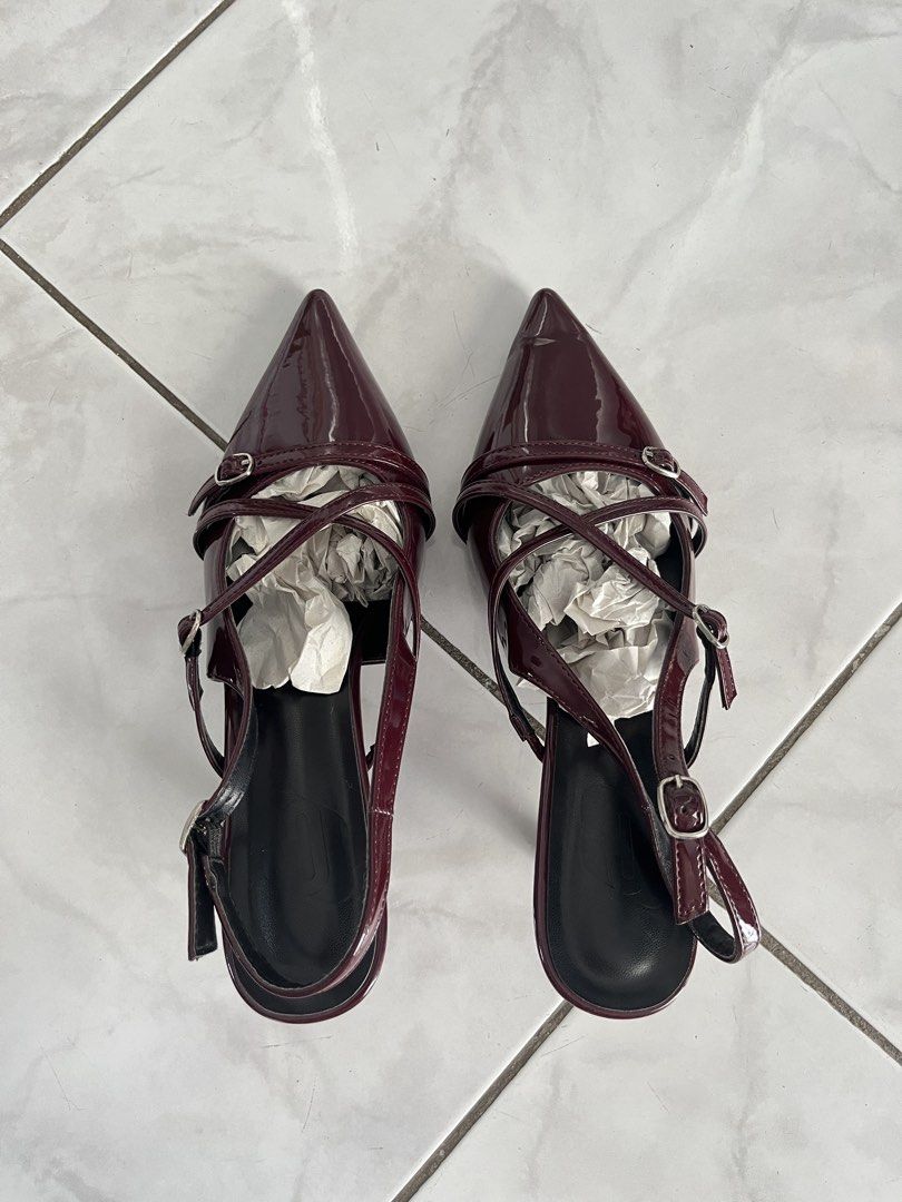 Burgundy Pointed Toe Slingback Heels (Category: Heels) located in Taguig. Submitted by sh4rk0_0 (Listing ID 1465612686, Image 1). Description: - Color & Finish: Stunning burgundy with a glossy patent leather look - Toe & Heel: Chic pointed toe paired with a comfortable kitten heel - Design: Multiple thin straps with small silver buckles across the top - Fit: Adjustable slingback strap for a secure and customized fit - Condition: Stuffed with pape