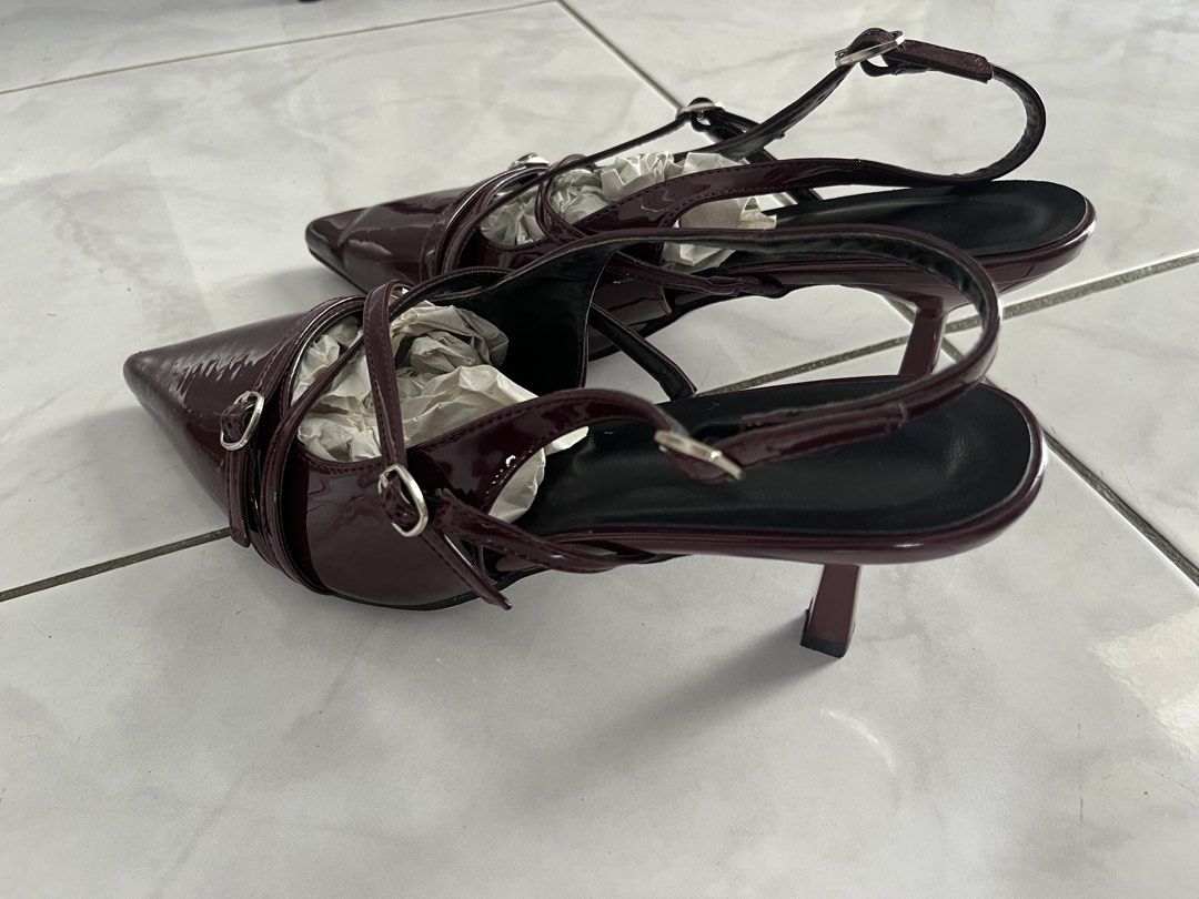 Burgundy Pointed Toe Slingback Heels (Category: Heels) located in Taguig. Submitted by sh4rk0_0 (Listing ID 1465612686, Image 2). Description: - Color & Finish: Stunning burgundy with a glossy patent leather look - Toe & Heel: Chic pointed toe paired with a comfortable kitten heel - Design: Multiple thin straps with small silver buckles across the top - Fit: Adjustable slingback strap for a secure and customized fit - Condition: Stuffed with pape