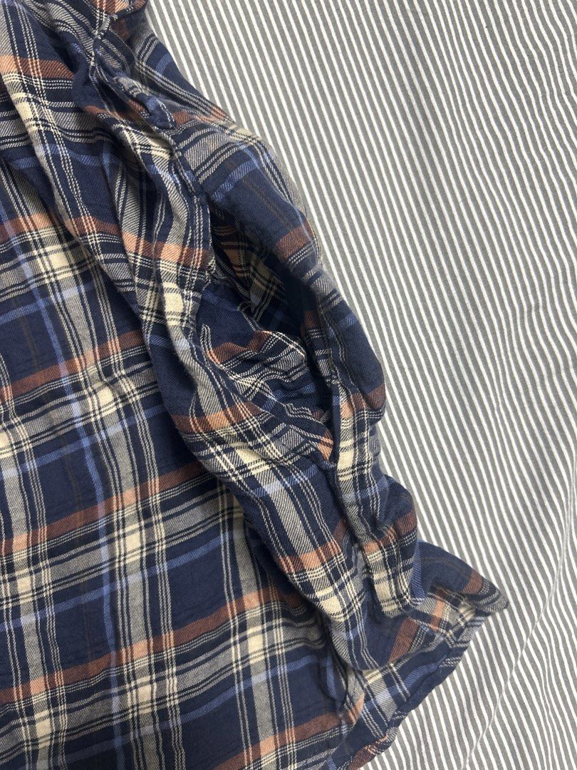 Button up blouse (Category: Blouses) located in Singapore. Submitted by swaninlouboutins (Listing ID 1465698313, Image 2). Description: Size: S to M ptp: 47.5 cm length: 69 cm - Material: Soft flannel-like fabric - Features: Short sleeves, button-front closure, classic collar, and stylish ruffle trim down the chest - Condition: Great for casual everyday wear or layering.