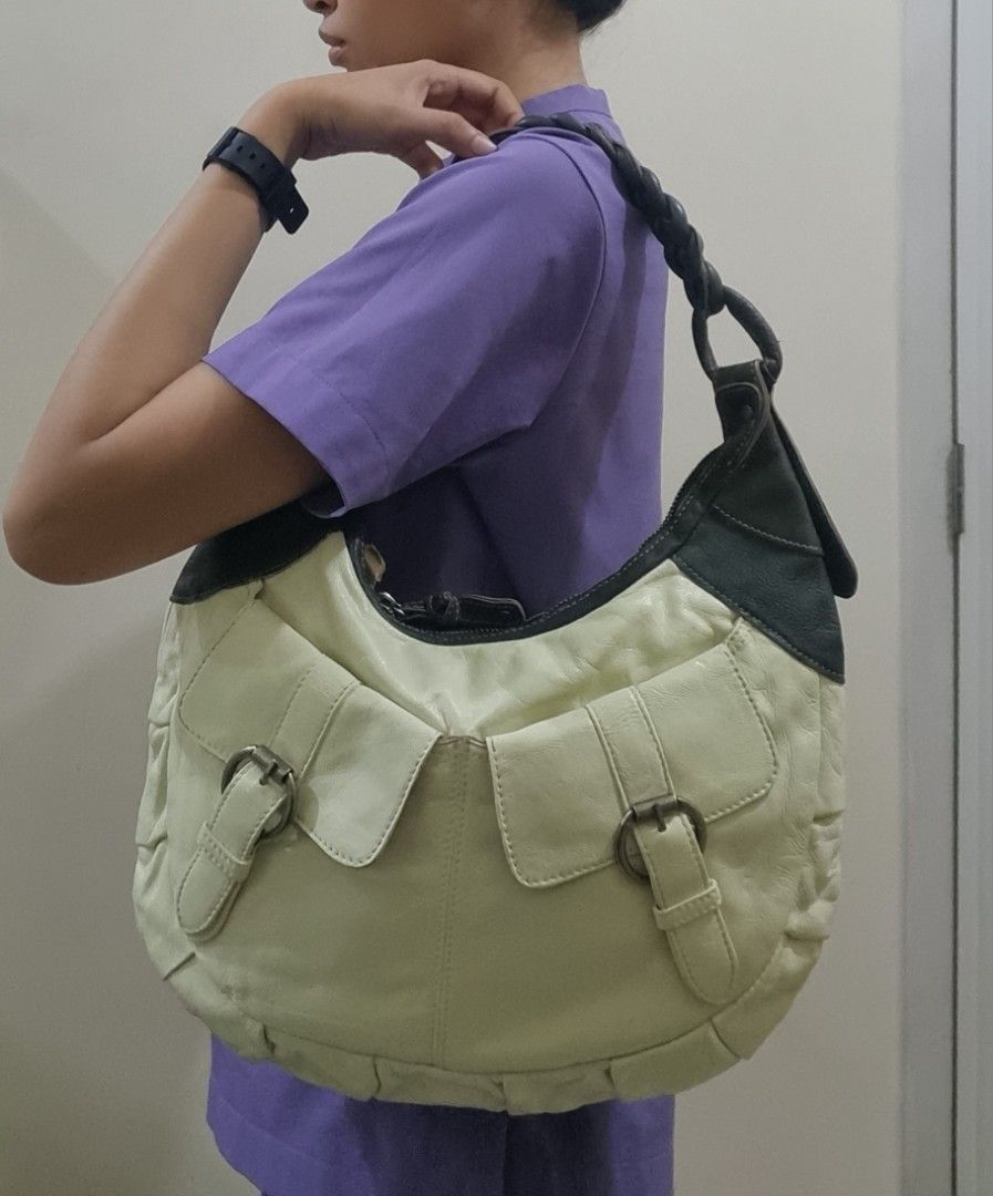 Buy 1 take 1 Kili bag (Category: Shoulder Bags) located in Quezon City. Submitted by gabdclutz (Listing ID 1465692099, Image 2). Description: FOR REFERENCE: MODEL HEIGHT 5'0 - Bag 1: Black canvas with leather trim, 13" x 7.5" with front buckle closure - Bag 2: Off-white leather, 15" x 9" with two front pockets and braided strap - Both ideal for daily use and errands - Clean interiors with smooth, fully functional zippers and closures METRO MANILA