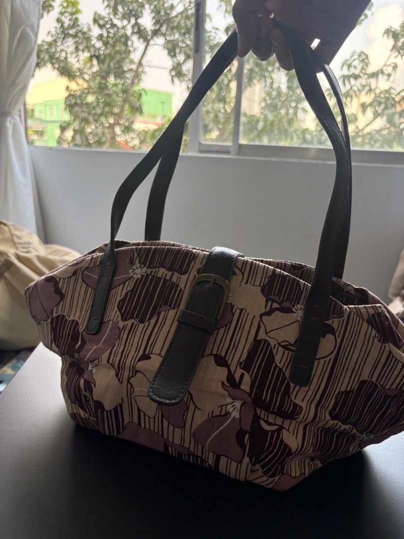 B1G1 Handbags (Category: Shoulder Bags) located in Manila. Submitted by curiouspicks (Listing ID 1465583034, Image 2). Description: - 2-in-1 Handbag Set: Includes a brown woven textured bag and a beige floral printed bag. - Spacious Interiors: Easily fits your wallet, phone, fans, and everyday essentials. - Design Details: Brown bag features braided handles and metal hardware; beige bag features thin straps and a front buckle closure. - Condition