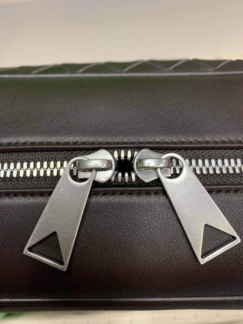 BV Intrecciato Leather Messenger Bag (Category: Luxury Bags & Wallets) located in Manila. Submitted by bagsandmanymanymore1 (Listing ID 1465599662, Image 3). Description: - Authentic BV messenger bag leather -Size 35cm - Features iconic intrecciato weave pattern on the base and bottom section - Secure zip closure with signature triangle zipper pulls - Adjustable leather shoulder strap with durable metal hardware - Light canvas interior lining equ