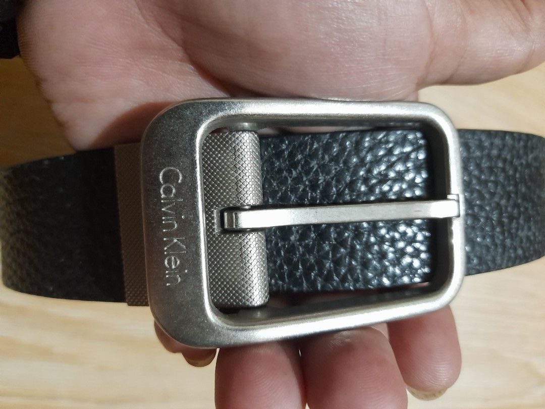 Calvin Klein Black Leather Textured Reversible Belt (Category: Belts) located in Bocaue. Submitted by marajapansurplus (Listing ID 1465708440, Image 2). Description: - Brand: Calvin Klein - Color: Black - Material: Textured leather - Hardware: Silver-tone metal buckle with engraved logo - Closure: Standard pin closure - Style: Classic and versatile for casual or smart outfits - Condition: Clean, with minimal signs of wear on leather and hardware 