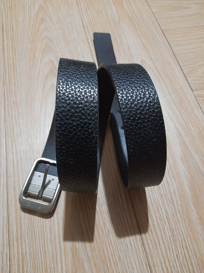 Calvin Klein Black Leather Textured Reversible Belt (Category: Belts) located in Bocaue. Submitted by marajapansurplus (Listing ID 1465708440, Image 1). Description: - Brand: Calvin Klein - Color: Black - Material: Textured leather - Hardware: Silver-tone metal buckle with engraved logo - Closure: Standard pin closure - Style: Classic and versatile for casual or smart outfits - Condition: Clean, with minimal signs of wear on leather and hardware 