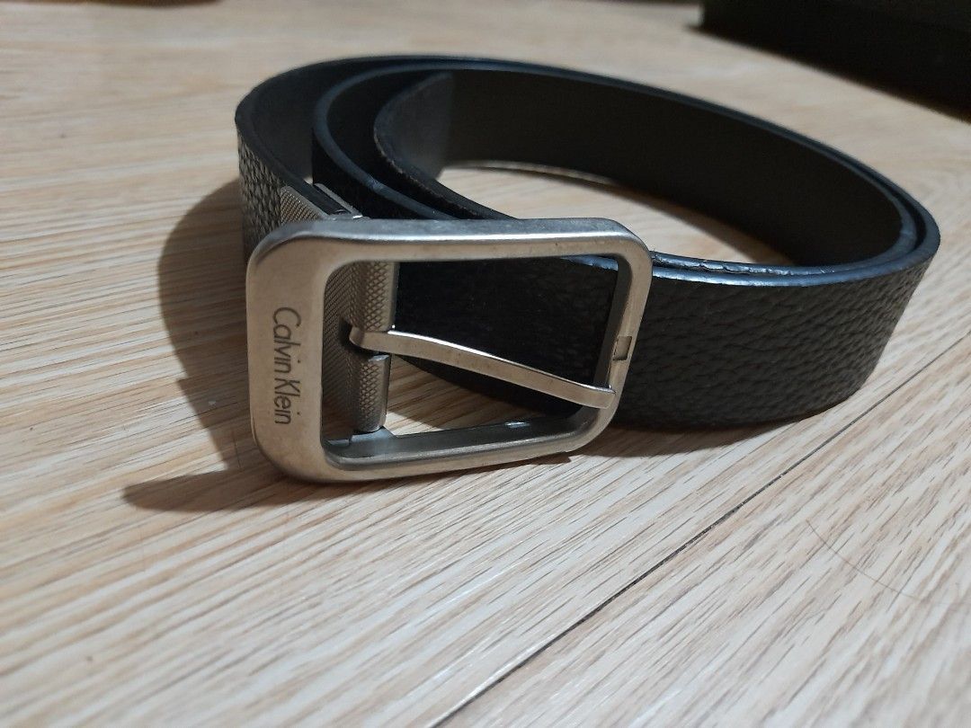 Calvin Klein Black Leather Textured Reversible Belt (Category: Belts) located in Bocaue. Submitted by marajapansurplus (Listing ID 1465708440, Image 3). Description: - Brand: Calvin Klein - Color: Black - Material: Textured leather - Hardware: Silver-tone metal buckle with engraved logo - Closure: Standard pin closure - Style: Classic and versatile for casual or smart outfits - Condition: Clean, with minimal signs of wear on leather and hardware 